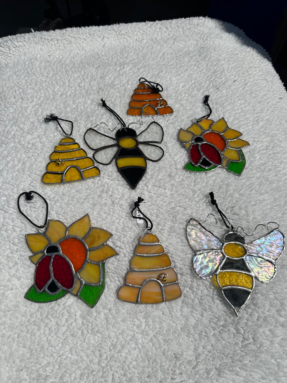 Stained glass beehives, bee, and sunflower ornaments