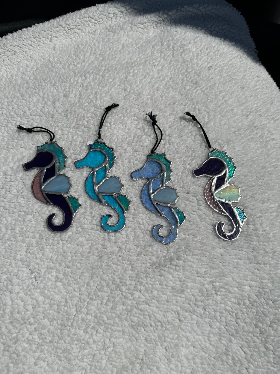 Four blue and teal stained glass seahorse suncatchers
